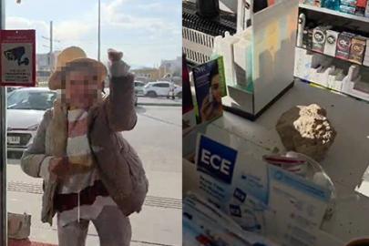 Fark ücreti vermek istemeyen kadın eczaneye taşla saldırdı